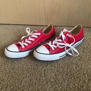 Woman’s red converse sneakers.